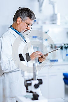 Senior male researcher carrying out scientific research in a lab