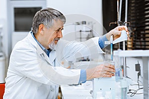 Senior male researcher carrying out scientific research in a lab