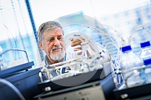 Senior male researcher carrying out scientific research in a lab