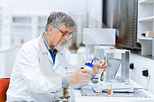 Senior male researcher carrying out scientific research in a lab