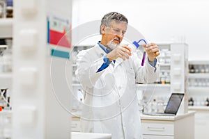 Senior male researcher carrying out scientific research in a lab