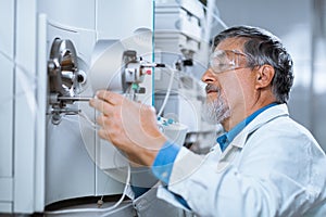 Senior male researcher carrying out scientific research in a lab