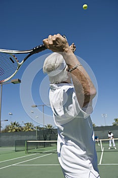 Senior Male Tennis Player Serving