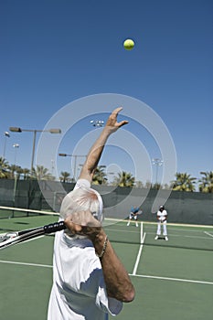 Senior Male Tennis Player Serving