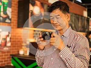 Senior males feel happy drinking coffee in the coffee shop