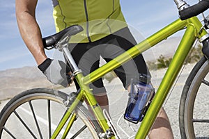 Senior Man Adjusting Bicycle Seat