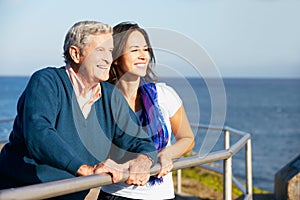 Senior Man With Adult Daughter Looking At Sea