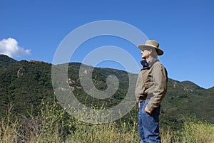 Senior Man Alone Looking at Mountains