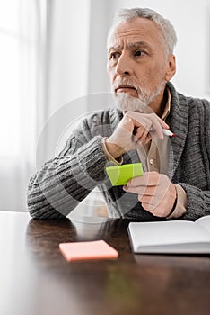 senior man with alzhemeirs disease holding