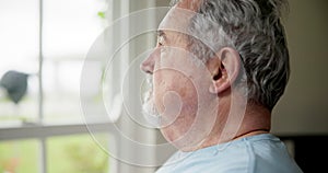 Senior man, anxiety and thinking on retirement, stress and worry by window for future. Elderly male person, depression