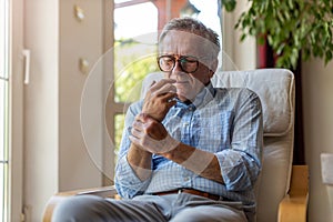 Senior man with arthritis rubbing hands