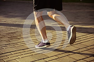 Senior man as runner with armband or fitness tracker at the city`s street