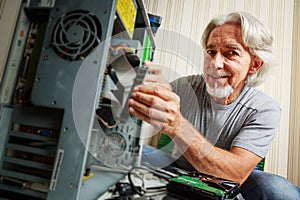 Senior Man Assembling Computer