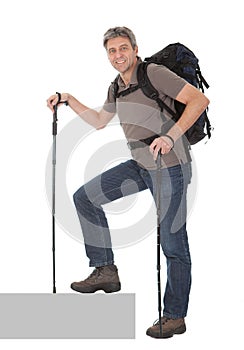 Senior man with backpack and hiking poles