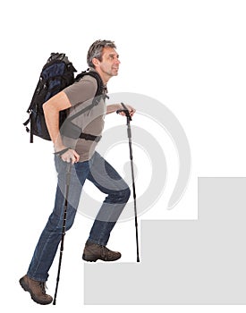 Senior man with backpack and hiking poles