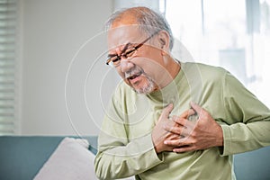 Senior man bad pain hand touching chest having heart attack
