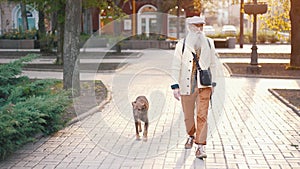 Senior man with beard walking with a dog