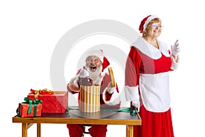 Senior man and beautiful middle-aged woman, Santa Claus and missis Claus in traditional New Year costume isolated on