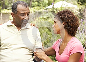 Senior Man Being Consoled By Adult Daughter