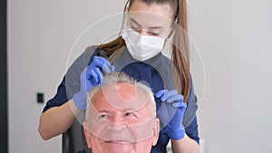 Senior man is being examined by a trichologist. Hair care concept.