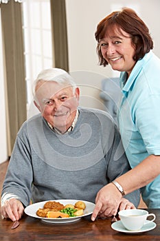 Senior Man Being Served Meal By Carer