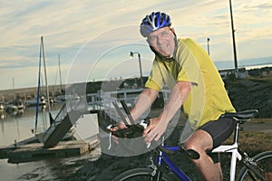 Senior man on bike at the sunset