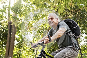 Senior man biking in the park