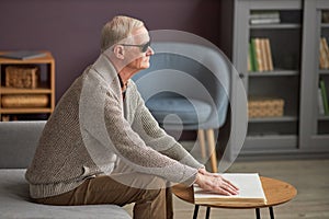 Senior man with blindness reading a book