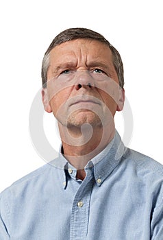 Senior man in blue shirt looks pensive