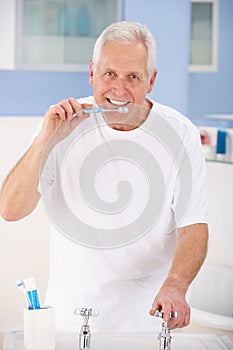 Senior man brushing teeth