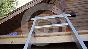 Senior man building a house by standing on scaffolding