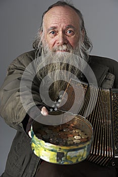 Senior Man Busking With Accordian