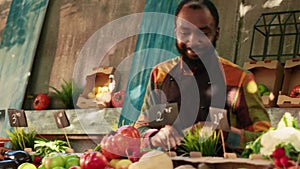 Senior man buying box filled with organic fresh produce from local farmers market