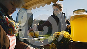 Senior man buys products at farmers market