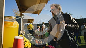 Senior man buys products at farmers market