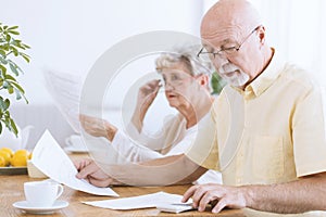 Senior man calculating household costs