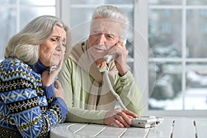 Senior man calling doctor with wife