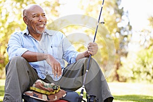 Senior Man On Camping Holiday With Fishing Rod