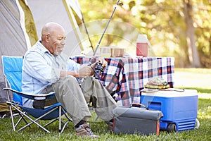 Senior Man On Camping Holiday With Fishing Rod