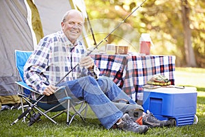 Senior Man On Camping Holiday With Fishing Rod