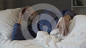 Senior man cannot sleep, suffering terrible headache and migraine, insomnia