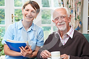 Senior Man With Carer At Home