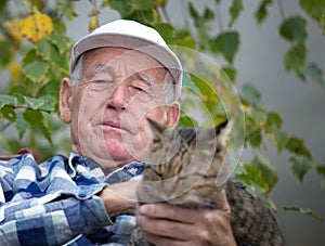 Senior man with cat in courtyard