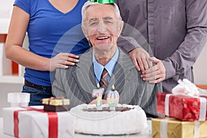 Senior man celebrating birthday with family