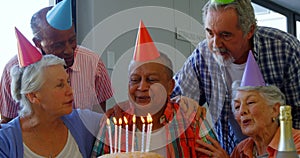 Senior man celebrating his birthday with friends 4k