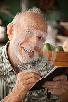 Senior man with checkbook photo