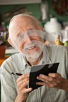 Senior man with checkbook photo