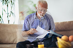 Senior man checking home finances.