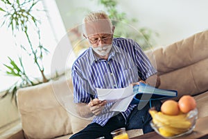 Senior man checking home finances