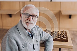 Senior man with chess board